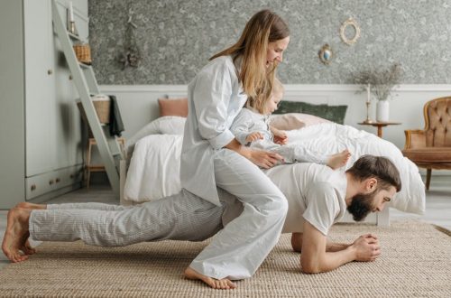 A joyful family enjoys playful bonding in a cozy bedroom, enhancing love and togetherness.